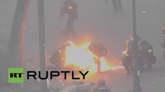 Petrol bomb strikes a Uktaine police officer during the Maidan "demonstrations" a year ago. 