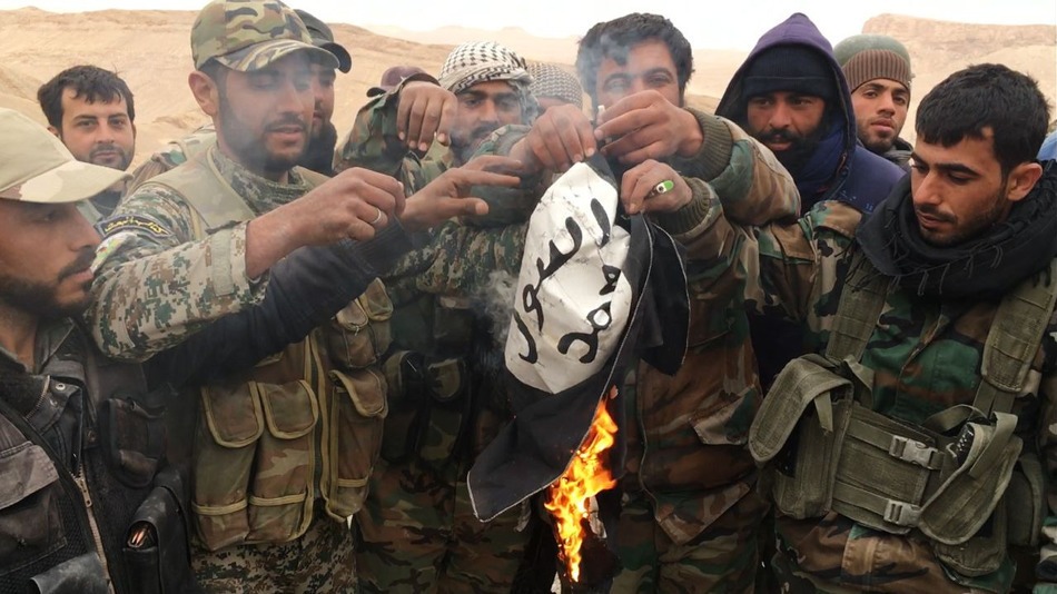 The Syrian Army burns the flag of ISIS after the liberation of Palmyra.